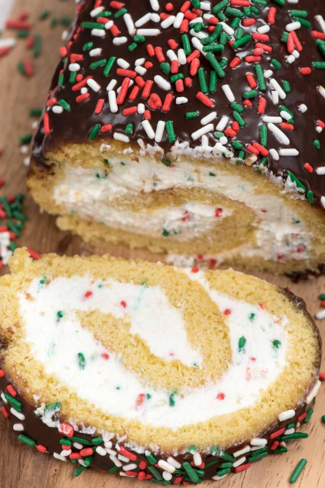 Make this Christmas Cake Roll for the perfect holiday dessert! A yellow cake roll filled with cream cheese whipped cream and sprinkles perfect for Christmas!
