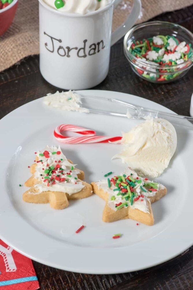 White plate with Christmas cookies and a mug in the background