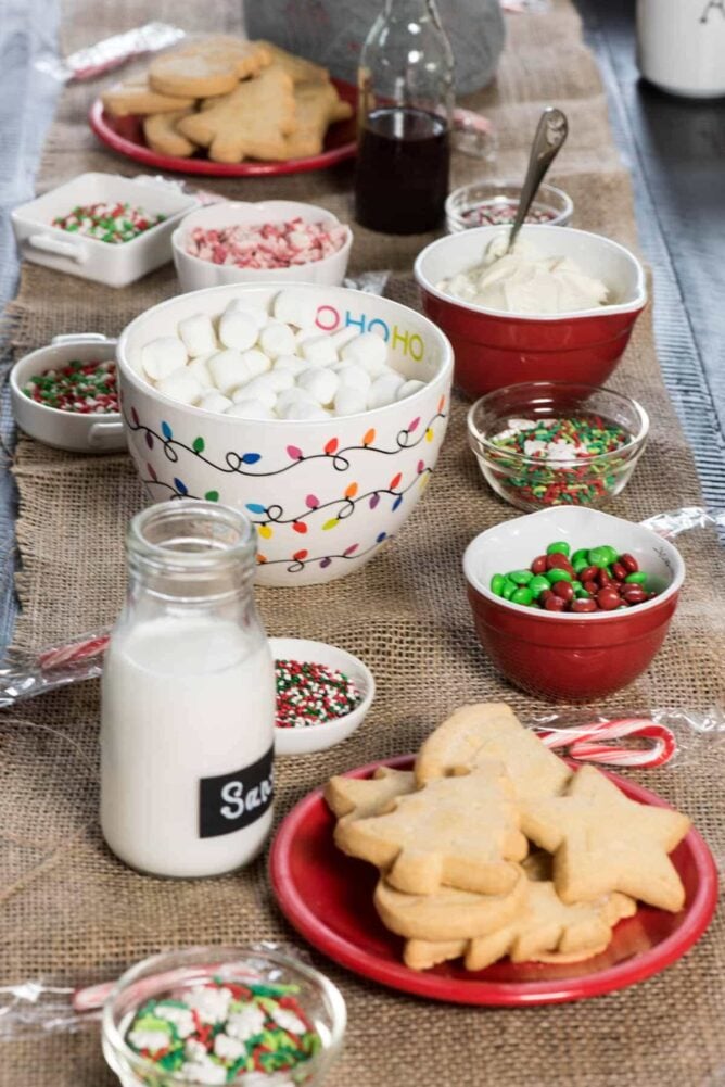 Table set up with all ingredients to decorate Christmas cookies