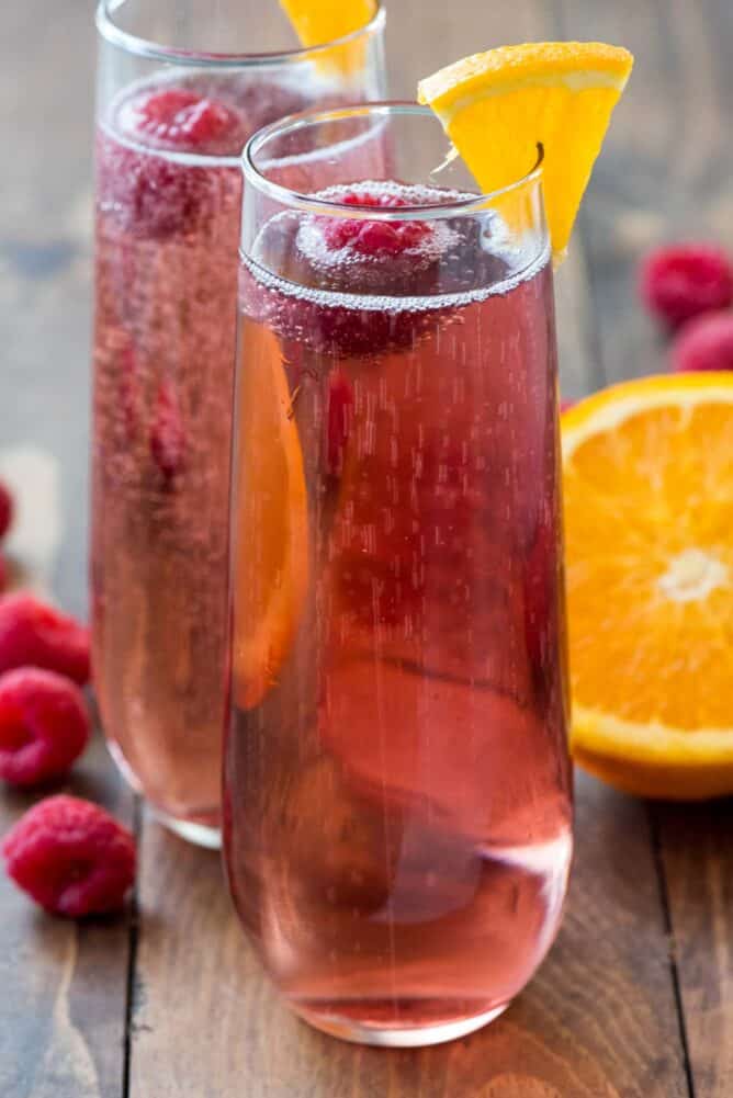 Two glasses of Pink Champagne Cocktail on a board