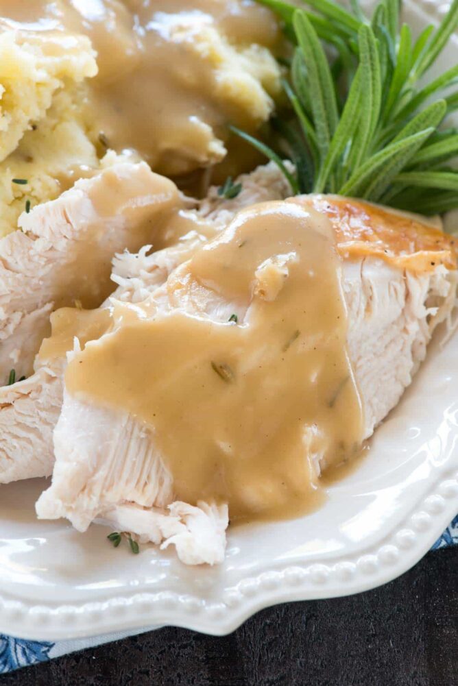 Turkey with gravy on a white serving platter