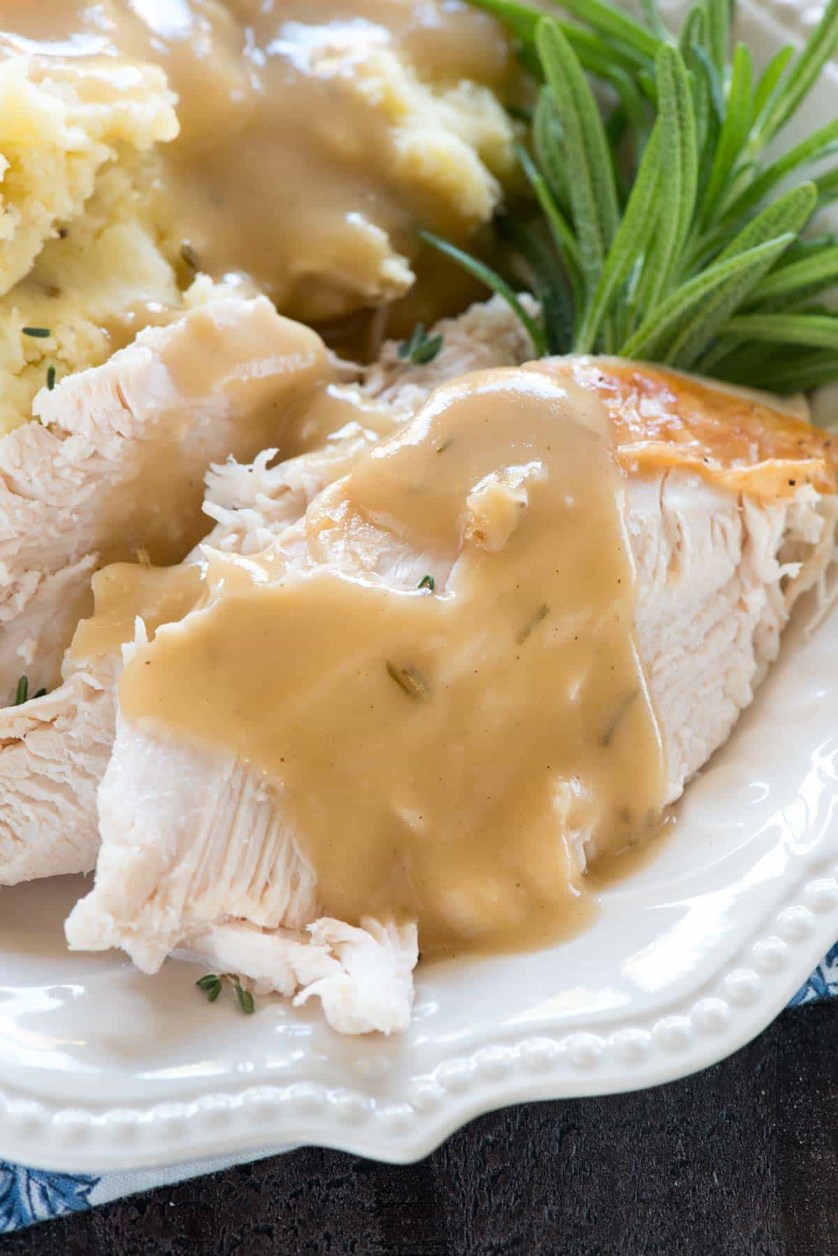 Turkey with gravy on a white platter