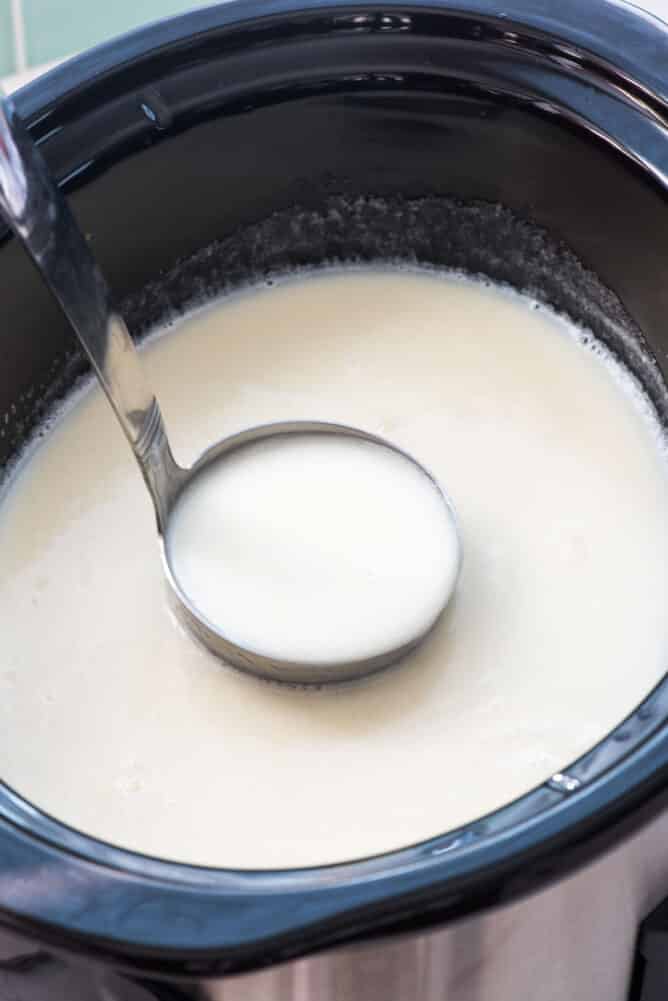 Crockpot White Hot Chocolate being ladled out of a crock pot