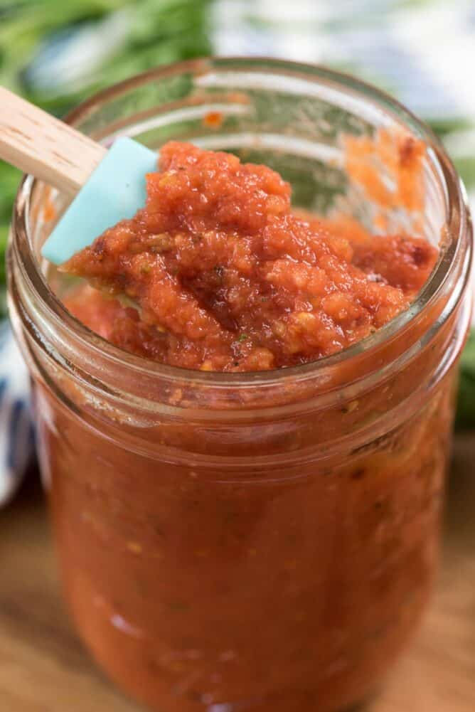 Close up of pizza sauce in a glass jar