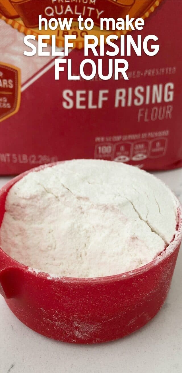 Flour in a red measuring cup with writing and a bag of flour