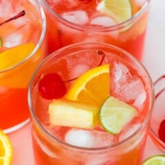 three glasses with vodka party punch and fruit