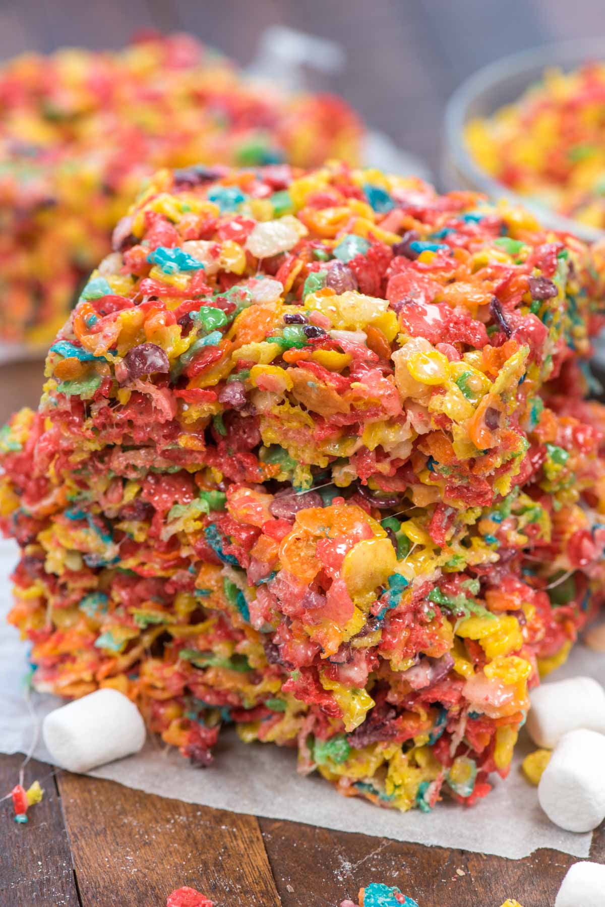 stack of fruity pebble kristpie treats on parchment paper