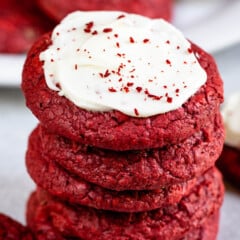 stack of red velvet cookies the top one has frosting