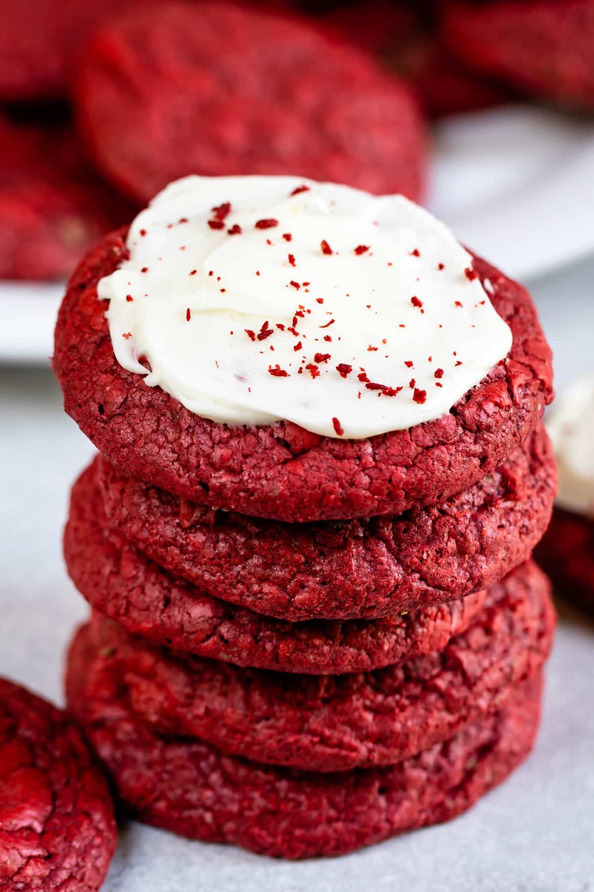 stack of red velvet cookies the top one has frosting