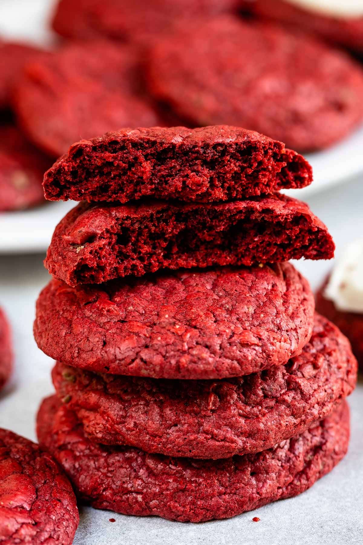 stack of red velvet cookies with the top one cut in half