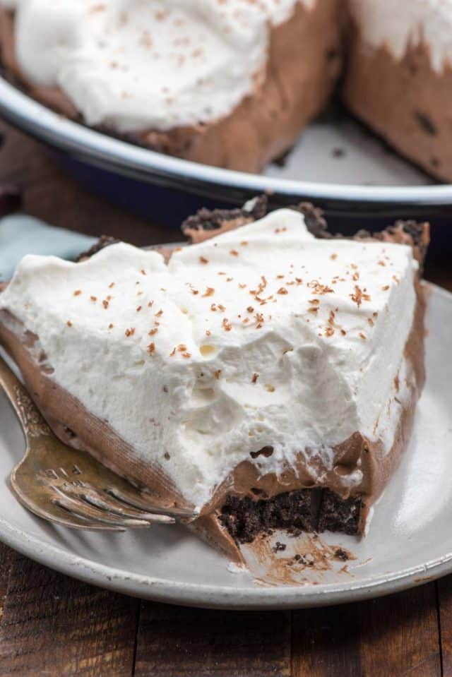 slice of pie on white plate with bite take out