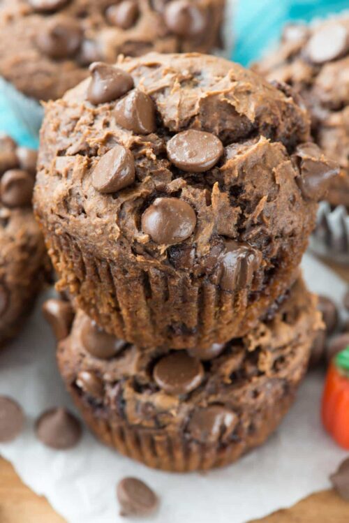 Chocolate Chip Pumpkin Doughnut Muffins stack on parchment paper