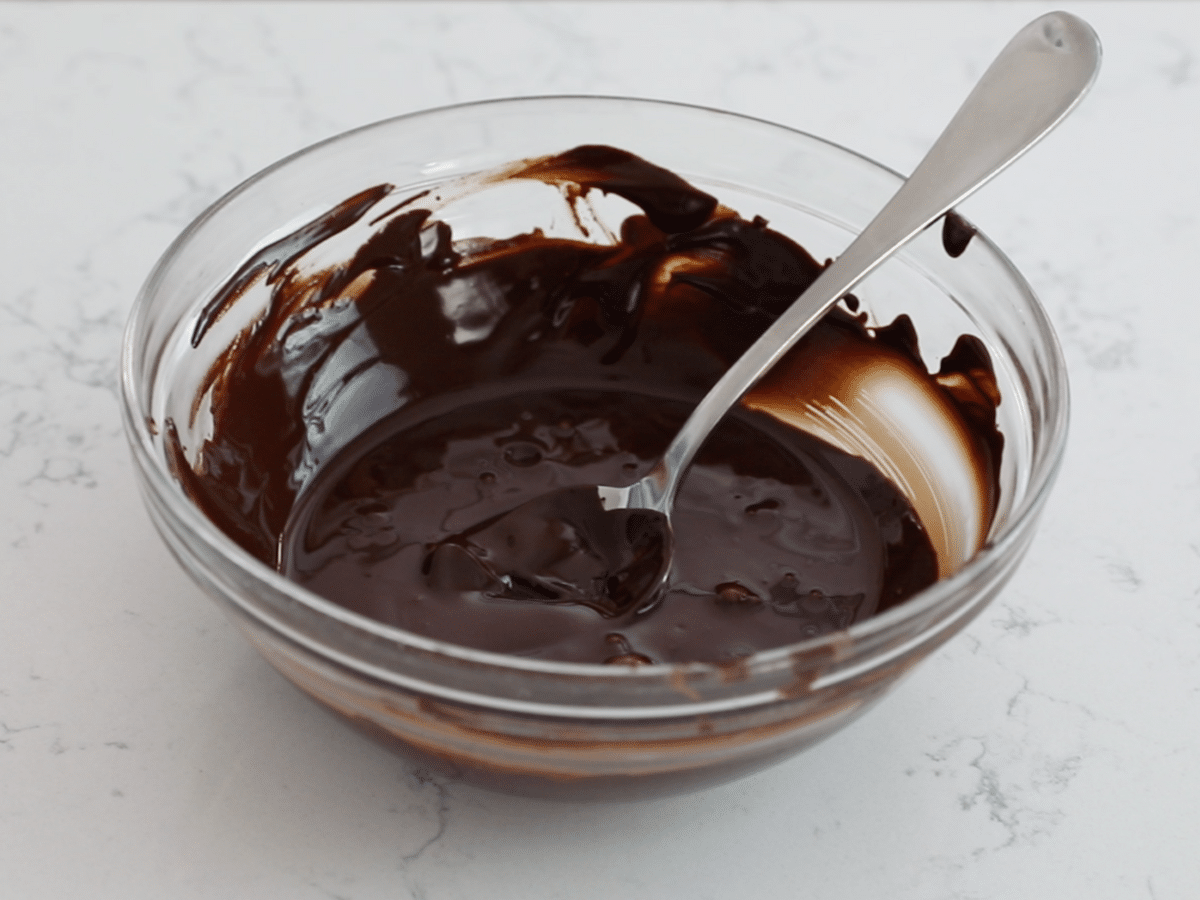 bowl of melted chocolate with spooon.