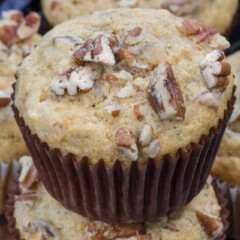 stack of banana nut muffins in brown liners