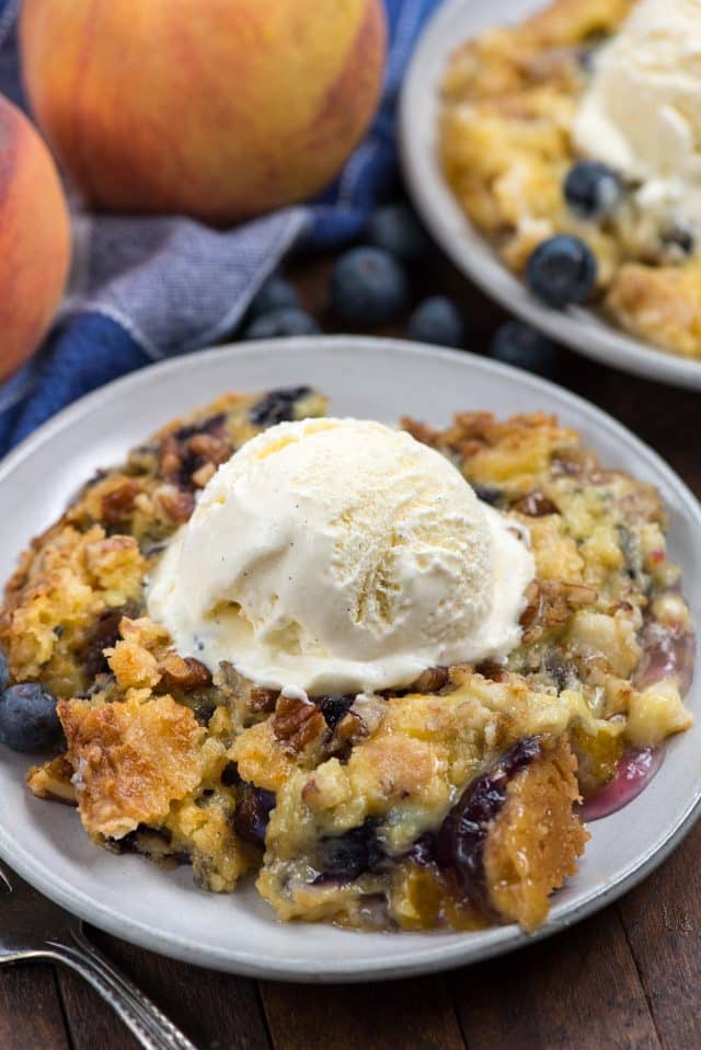 blueberry peach cake on plate with ice cream
