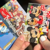 hands holding Disneyland tickets