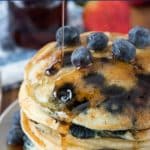 stack of blueberry pancakes on white plate