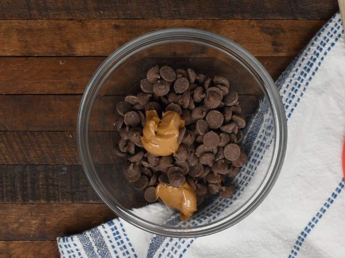 chocolate chips and peanut butter in clear bowl.