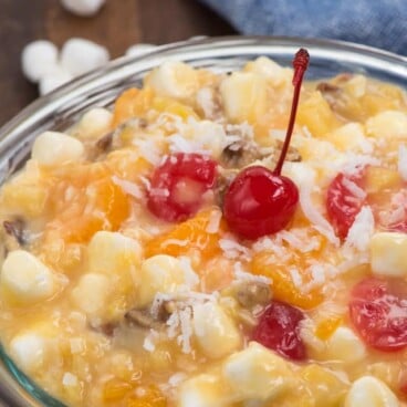 Tropical Ambrosia Salad in a glass bowl with writing