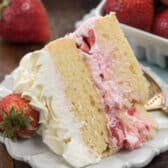 slice of strawberry shortcake layer cake on plate