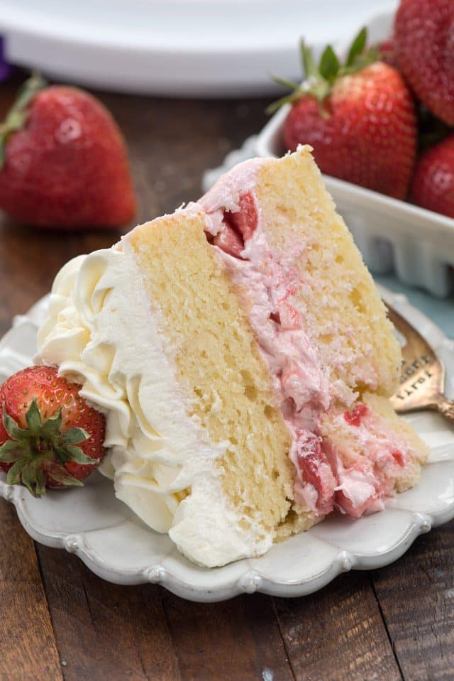 slice of strawberry shortcake layer cake on plate