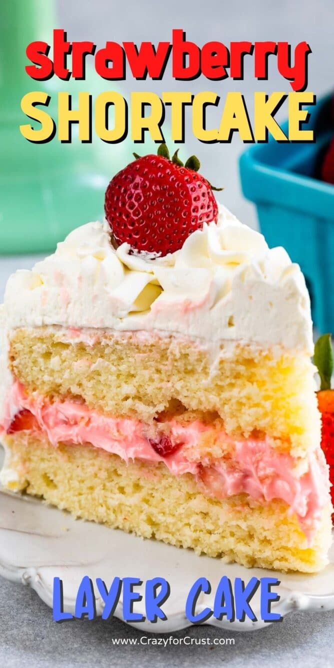 slice of strawberry shortcake layer cake on white plate with fresh berries on top
