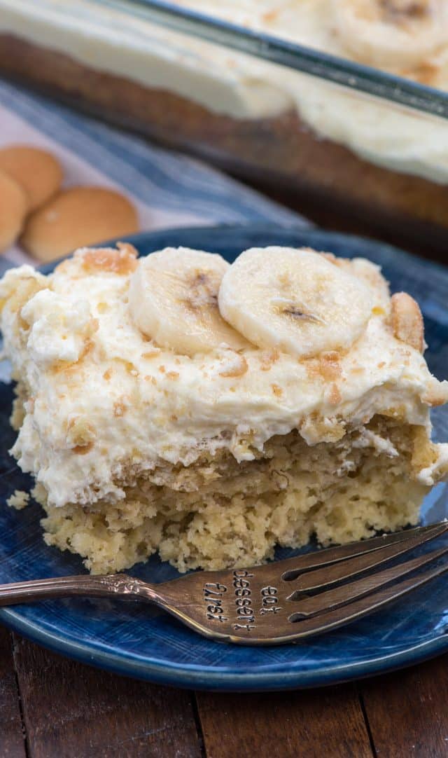 slice of banana pudding cake on a blue plate with a fork