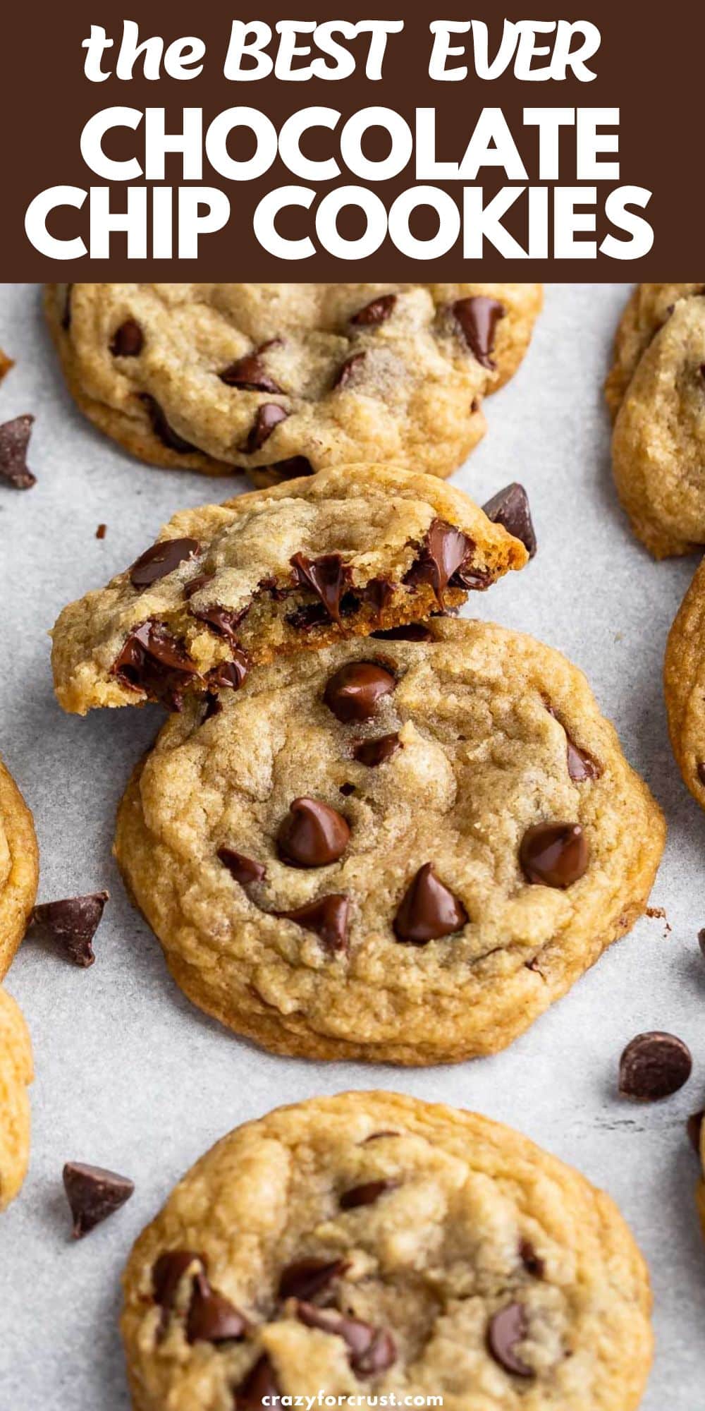 chocolate chip cookies on gray background with one cut in half