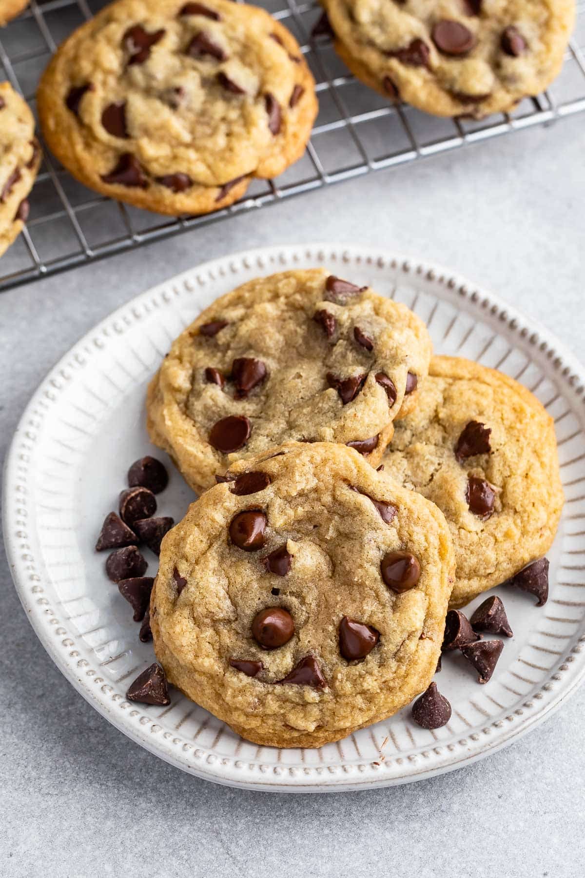 3 cookies on white plate with rack behind