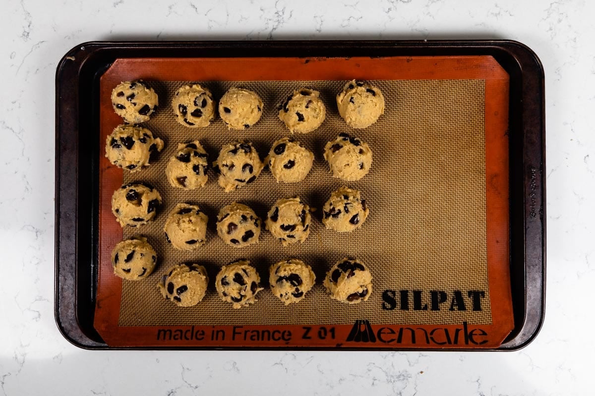 cookie dough balls on cookie sheet.