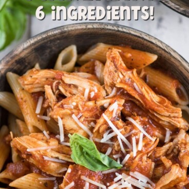 chicken and pasta with sauce in wood bowl