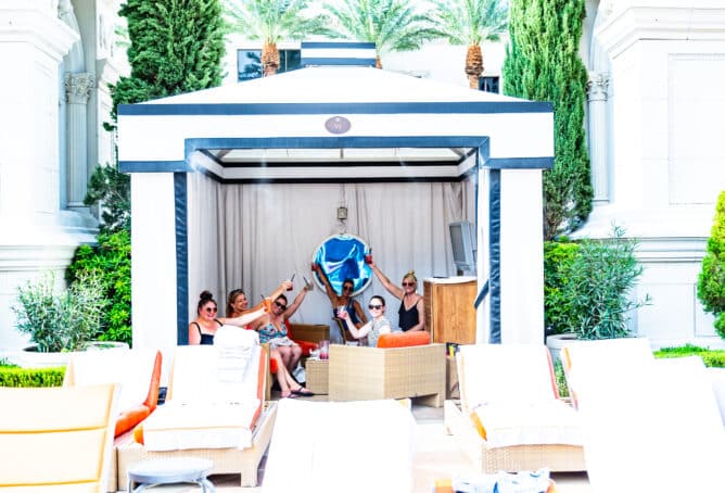 6 Women in a cabana holding up drinks