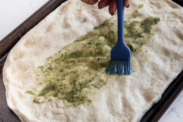 brushing dough with ranch mix