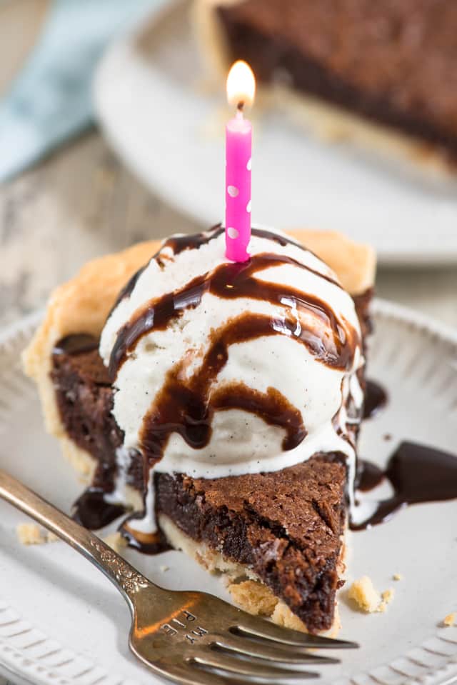 chocolate fudge pie with ice cream and candle 