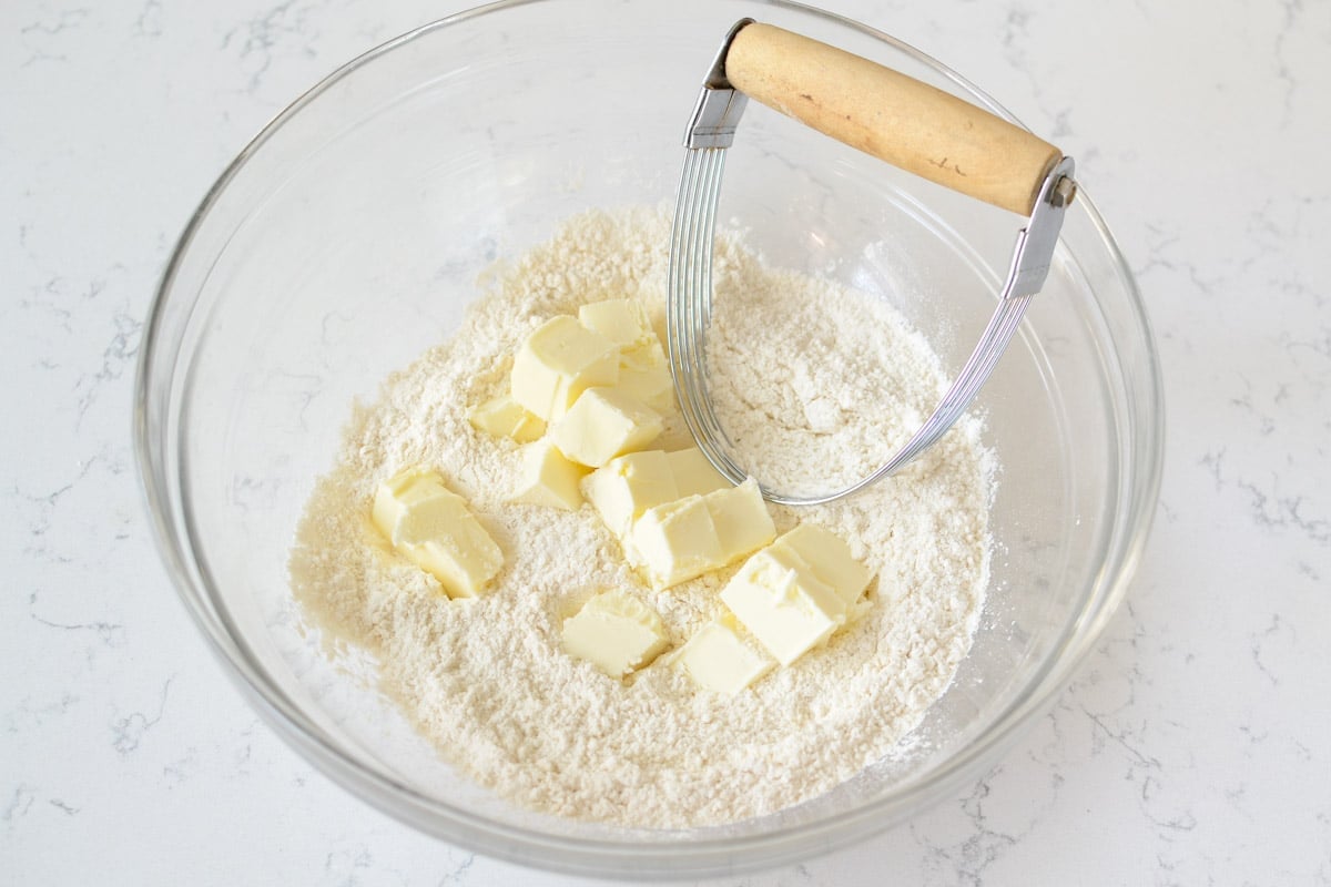 bowl of flour and butter with a pastry cutter