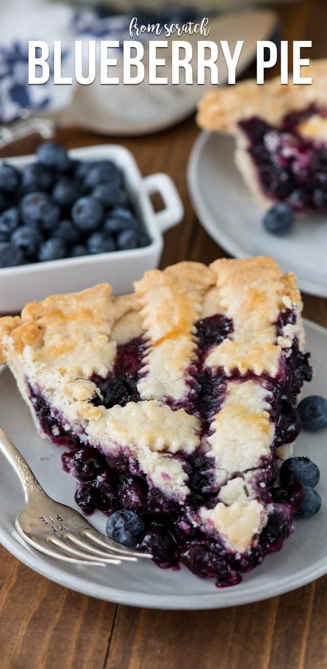 slice of blueberry pie on a white plate with a fork