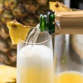 pouring champagne pineapple mimosa