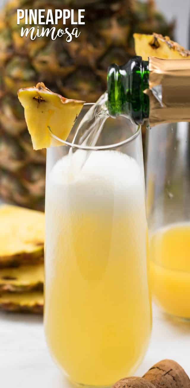 pouring champagne into pineapple mimosa