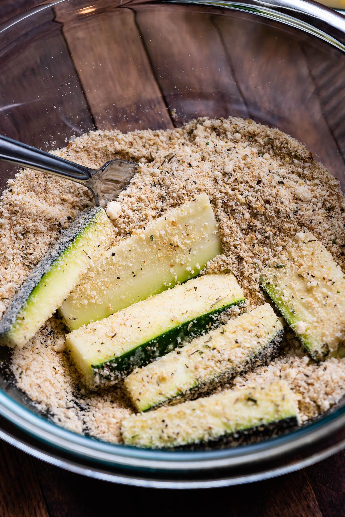 bowl with spice mixture coating zucchini.