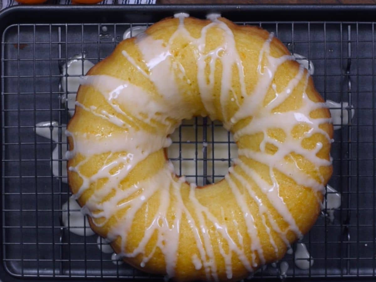 cake on rack with drizzled glaze.