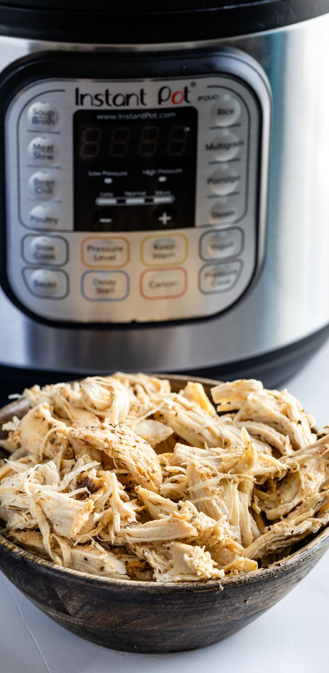 instant pot and shredded chicken in bowl