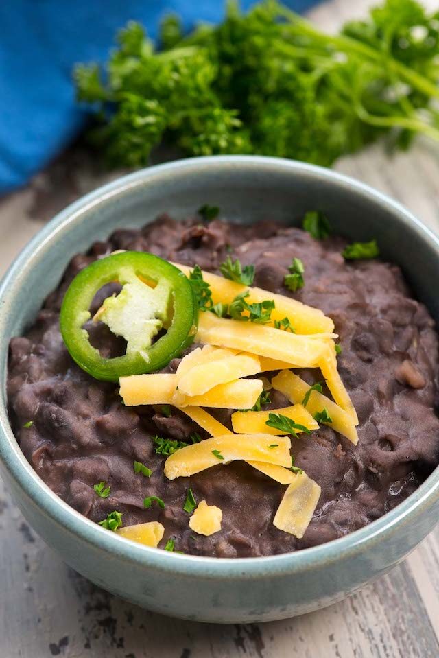 refried black beans in blue bowl