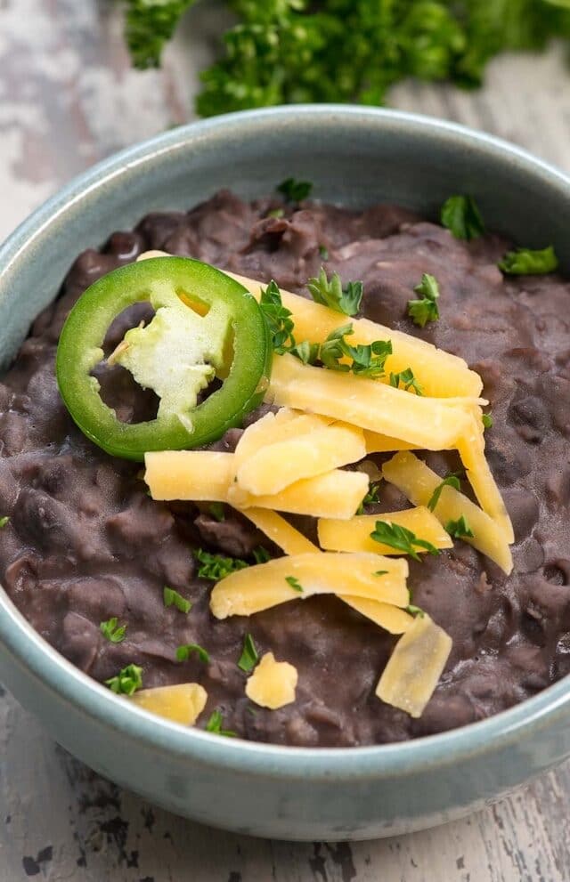 refried black beans in blue bowl