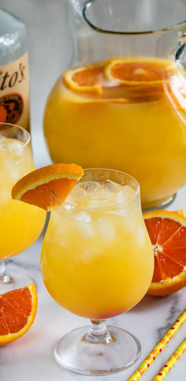 orange party punch in glass and pitcher