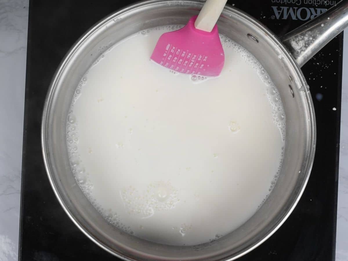 milk in saucepan with spatula.