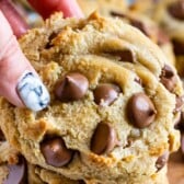 hand holding giant chocolate chip cookie