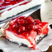 slice of no bake cherry cheesecake dessert on white plate