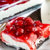 slice of no bake cherry cheesecake lush on white plate