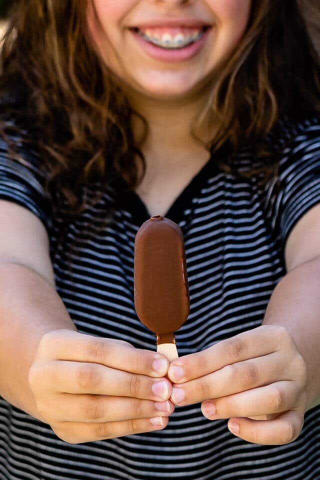 girl holding ice cream bar