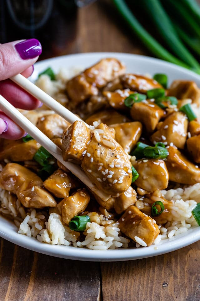 teriyaki chicken on white plate with chopsticks